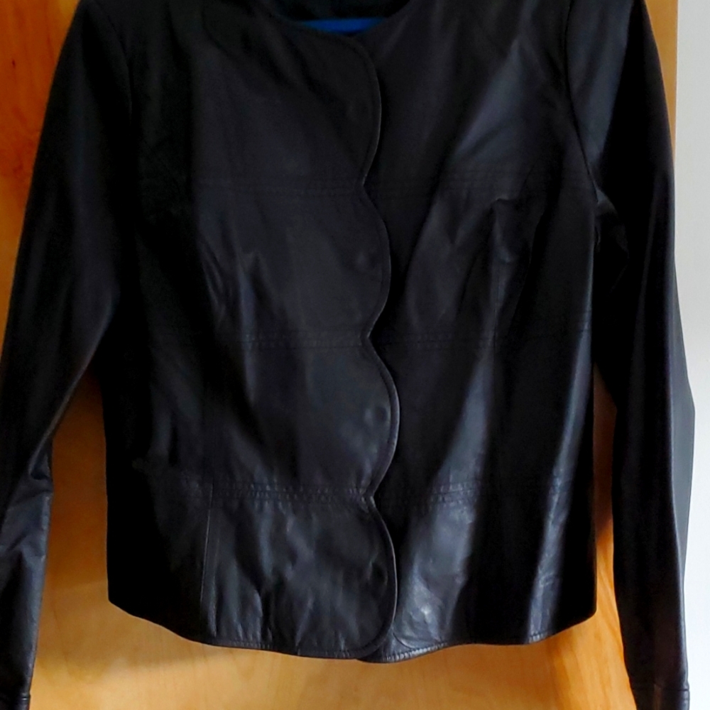 Fitted leather jacket. Princess seams. Scalloped front with snaps.